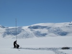 photo of researchers setting up a gps station on flask glacier